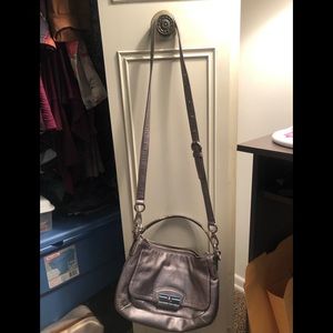 Coach silver bag - used the outside is in good condition. inside has pen marks